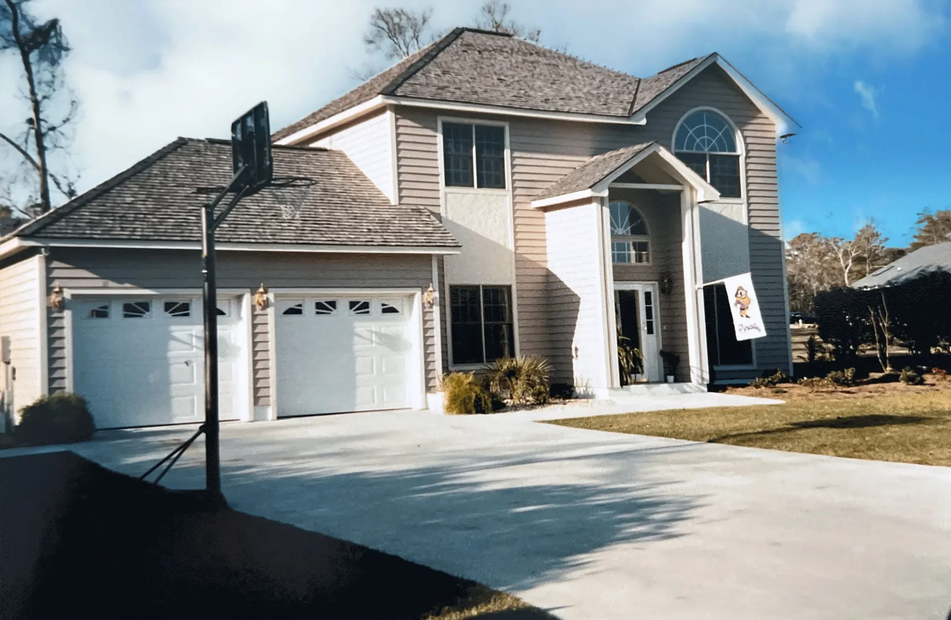 Two-story home with architectural shingles, fiber cement siding, two-car garage, and concrete driveway